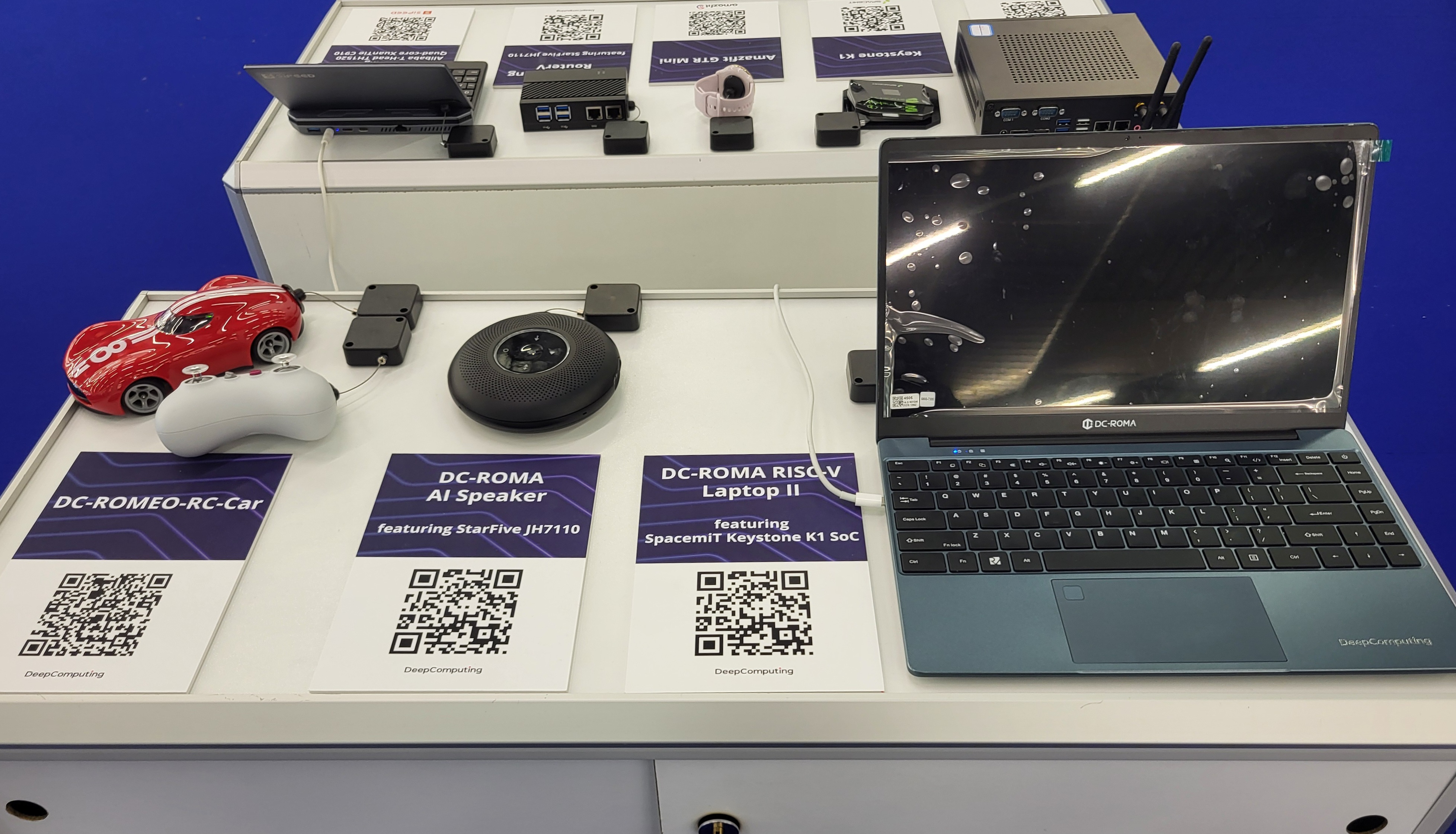 One of the hardware exhibition tables with DC-ROMA RISC-V Laptop II.